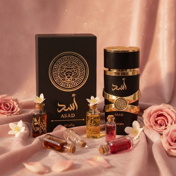 Close-up of Desert Bloom Luxe Perfume bottle surrounded by small vials of Arabic oils and delicate floral petals on a blush p